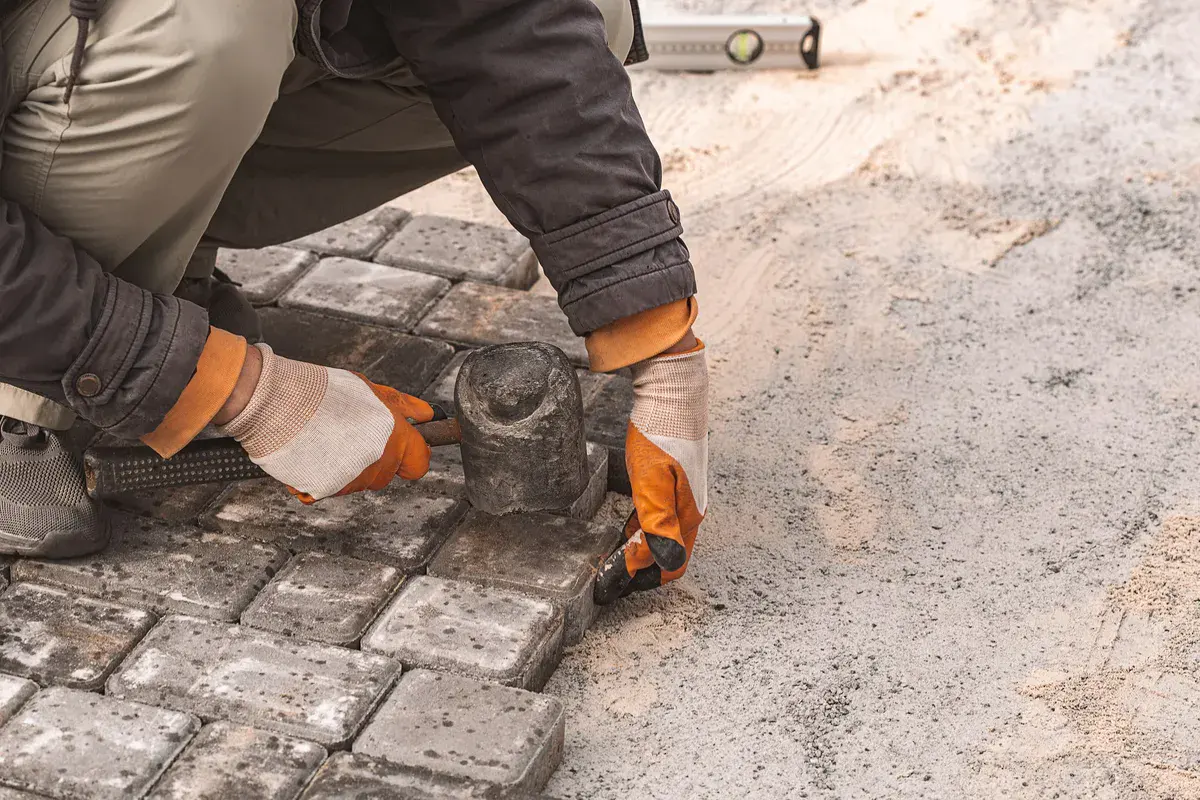 Closeup of paving slabs being laid for road surface construction and sidewalk repair.